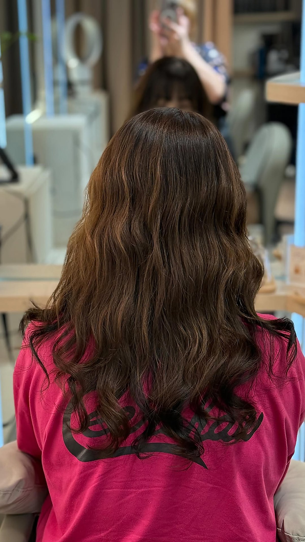 Long wavy hair styling result, soft layered finish