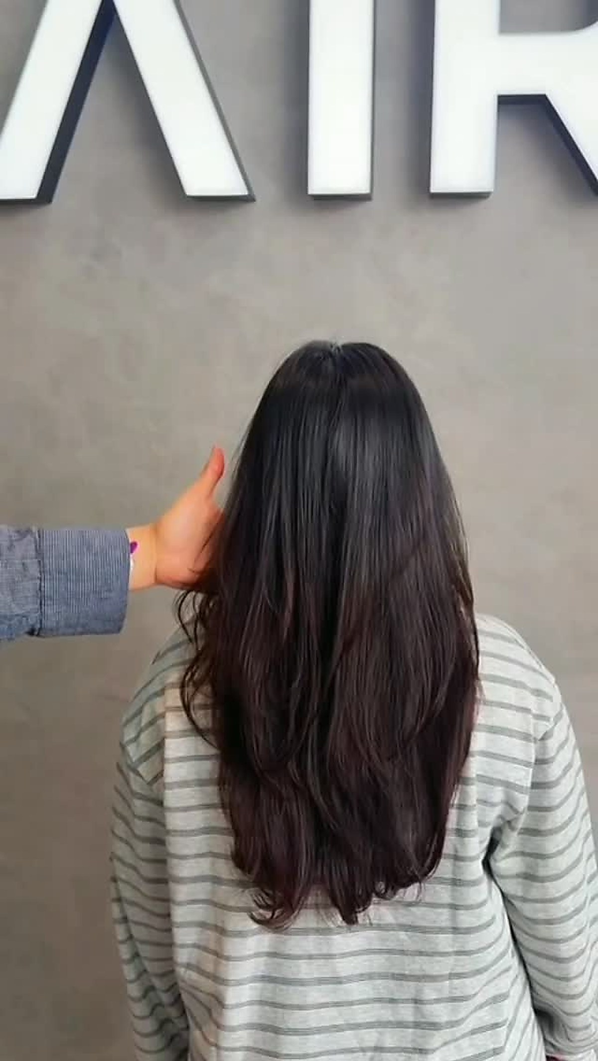 Long, dark hair styled and finished