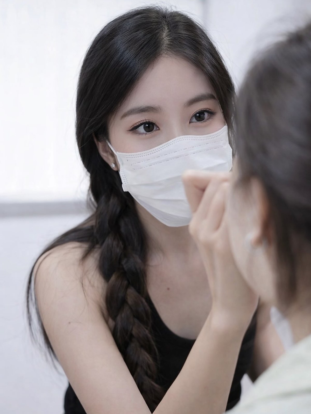 Client wearing a mask during a quiet lash session