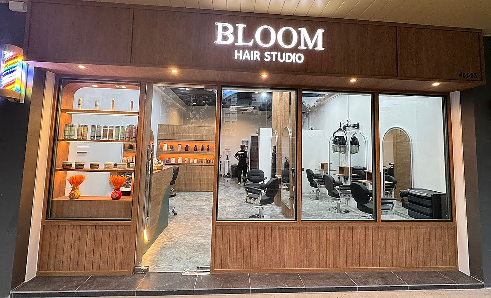 Modern salon storefront interior at Bloom Hair Studio with warm wood finishes