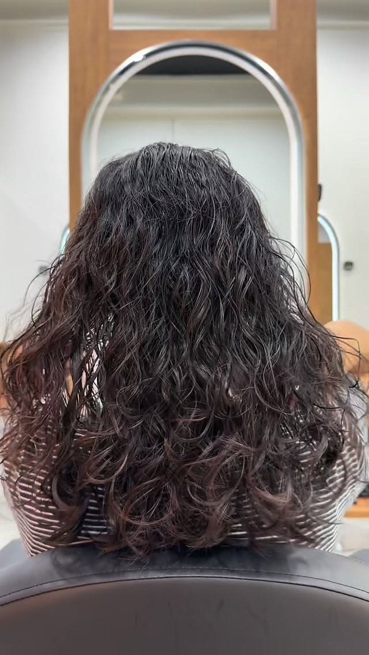 Long wavy hair styling result with soft texture