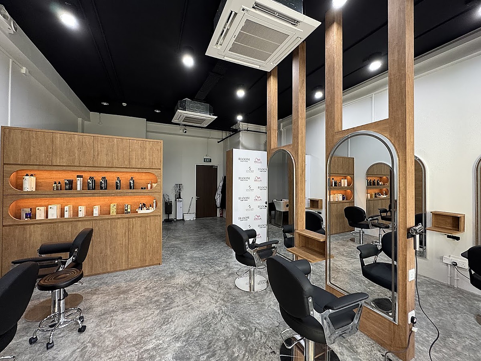 Modern salon interior with arched mirrors at Bloom Hair Studio Pasir Ris