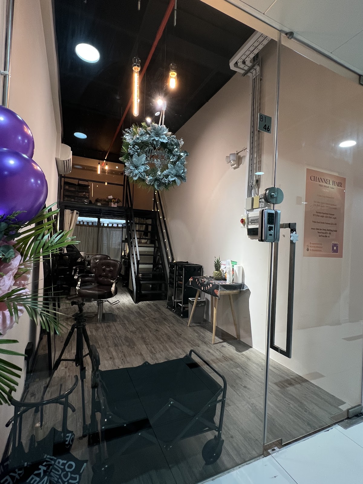 Modern dimly-lit salon interior entrance at Channel Hair