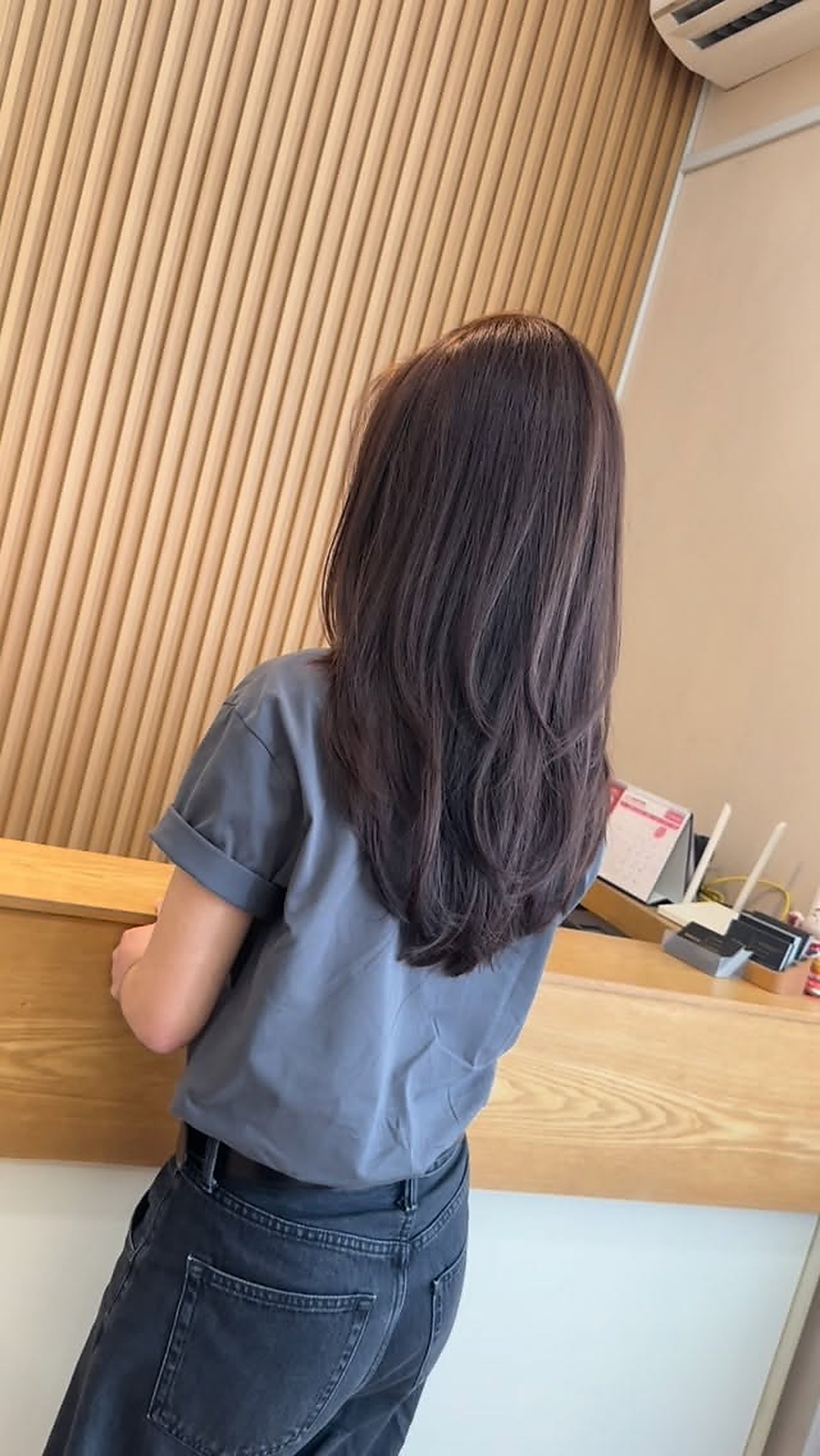 Medium length dark hair style finished at D hair salon
