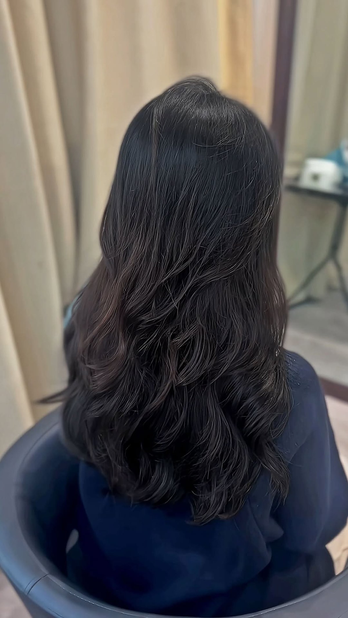 Long dark wavy hair styling result at D hair salon