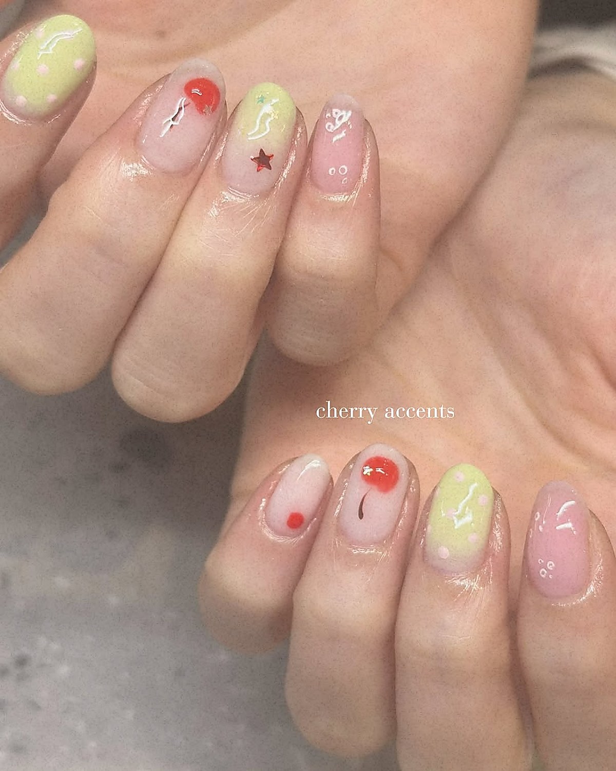 Nail art with cherry accents on dark base