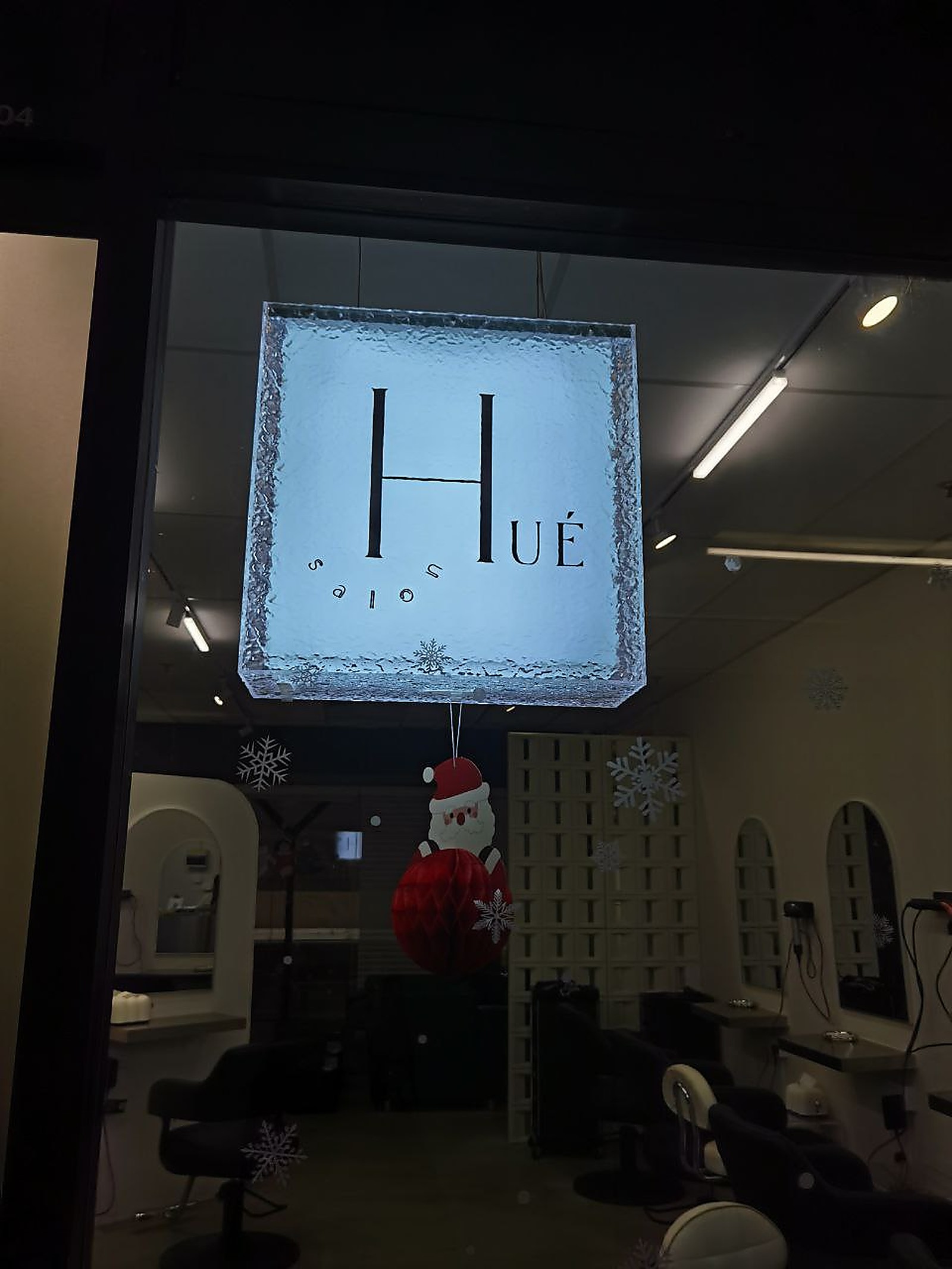 Holiday window display at Hue Salon Sg, warm interior view