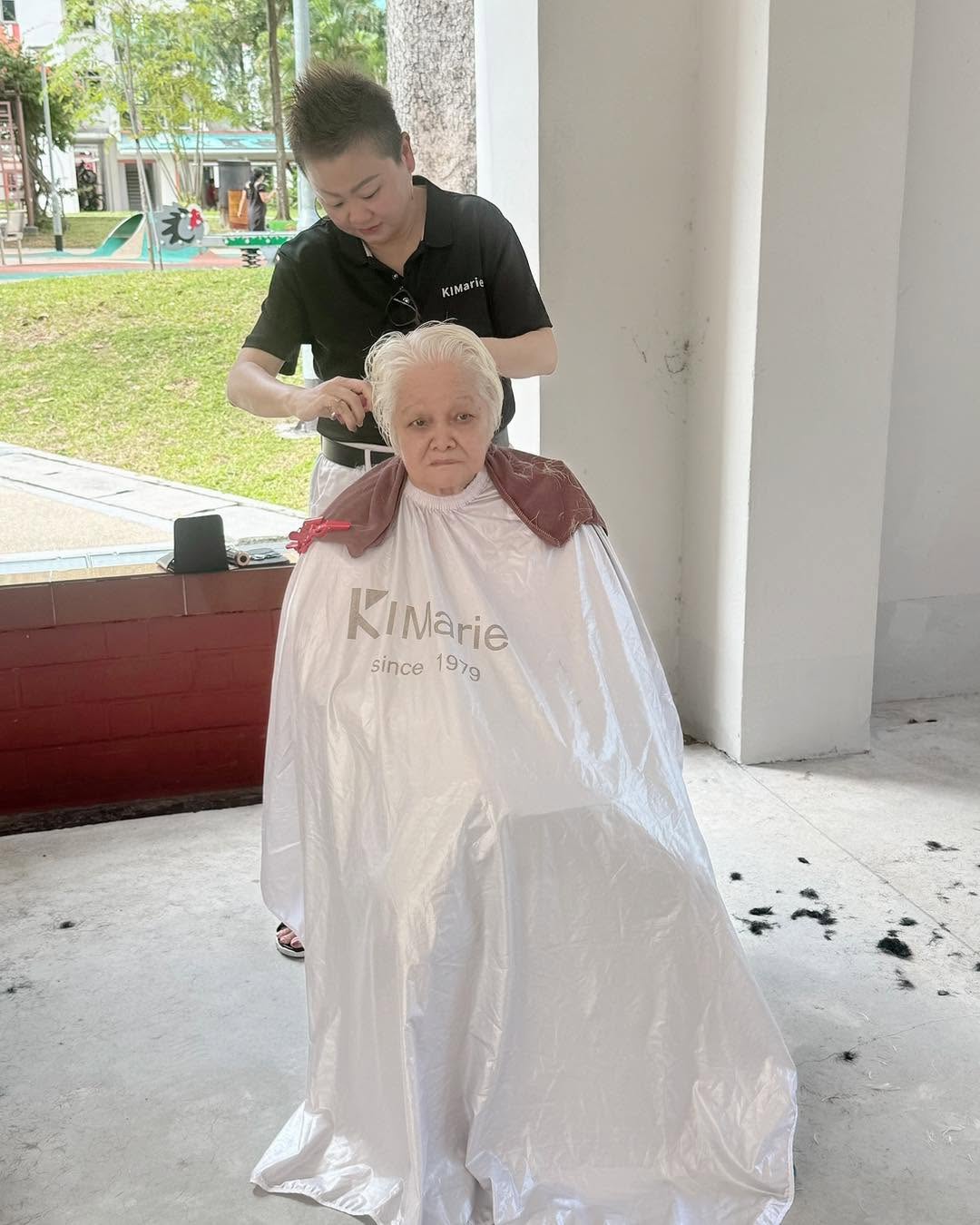 Stylist finishing a hair styling session with a senior client at Inspiration Hair Approach