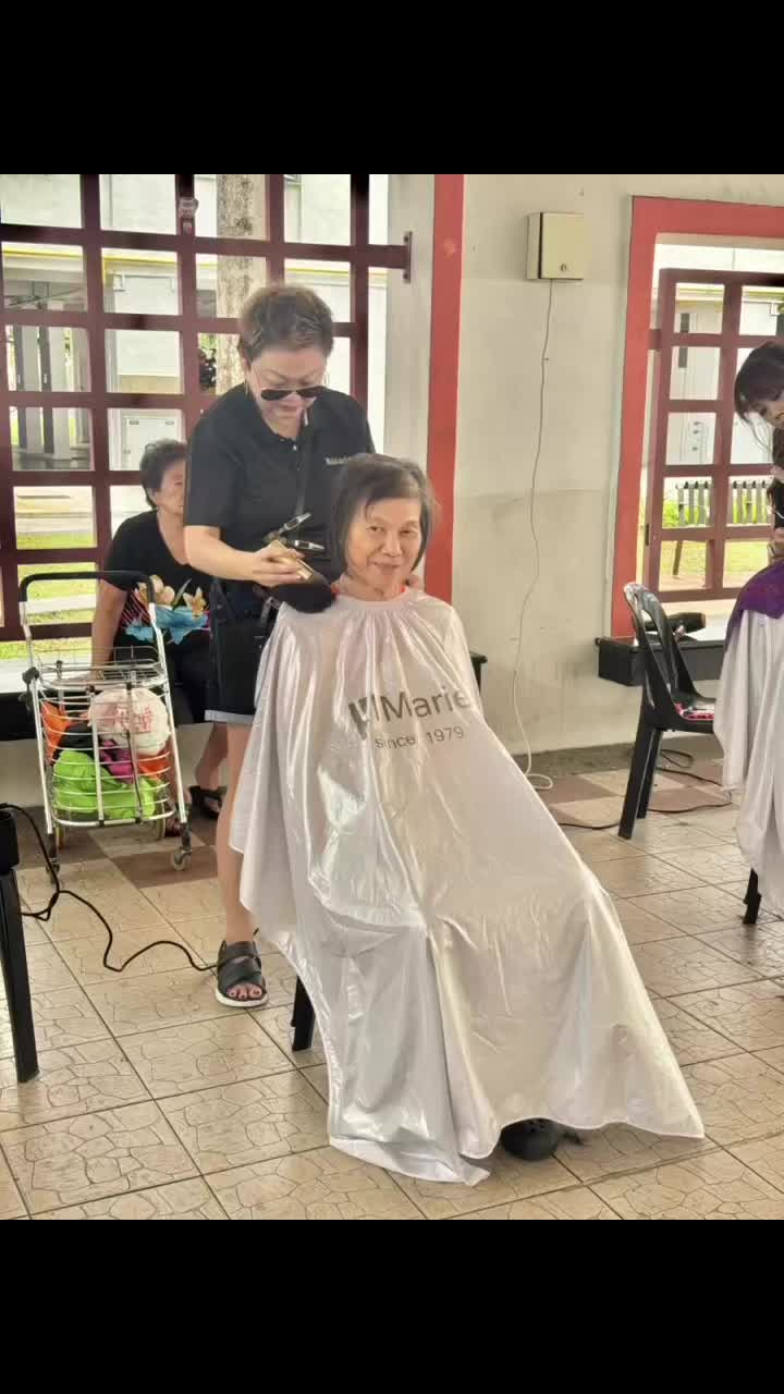 Haircut and styling service in progress on the salon floor