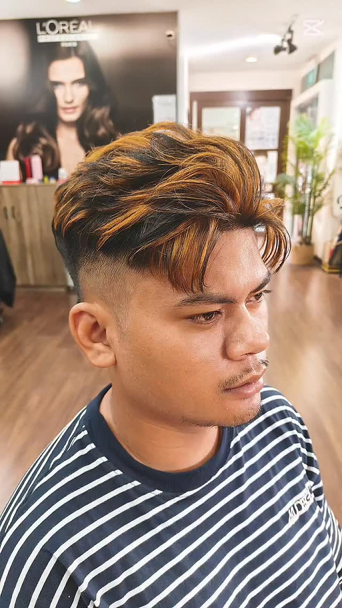 Men's undercut styling with bronze highlights
