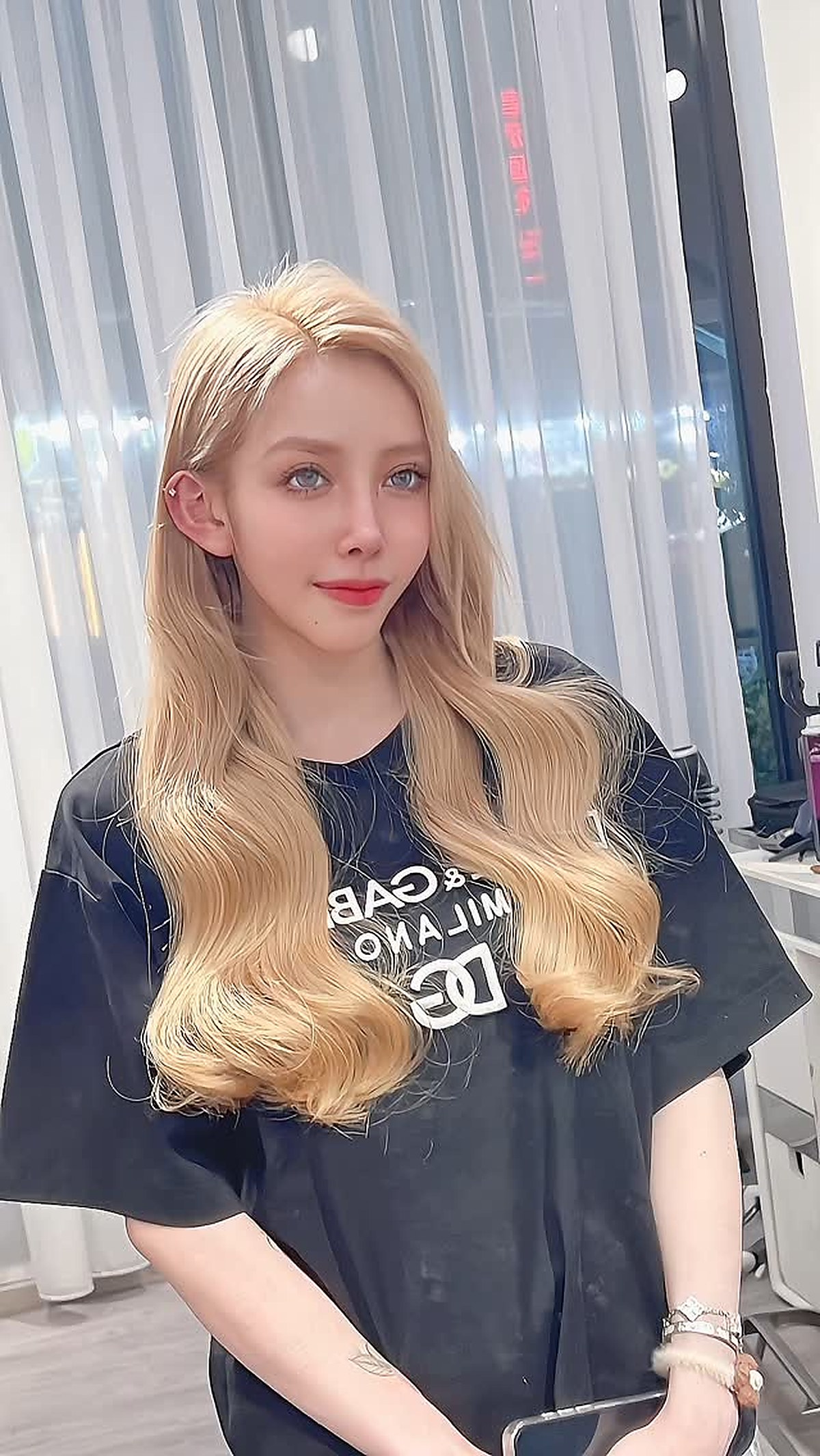 Long blonde hair styled smooth and full