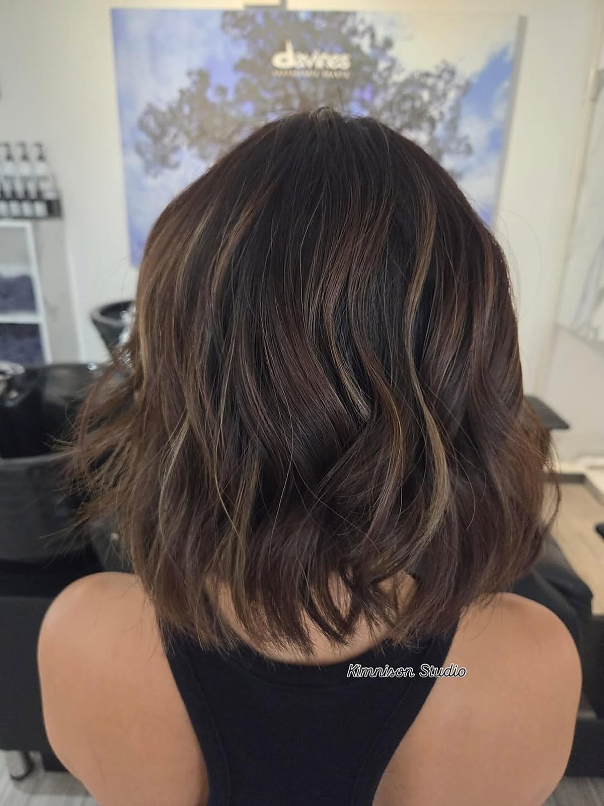 Brunette balayage on wavy hair styled at Kimnison Studio