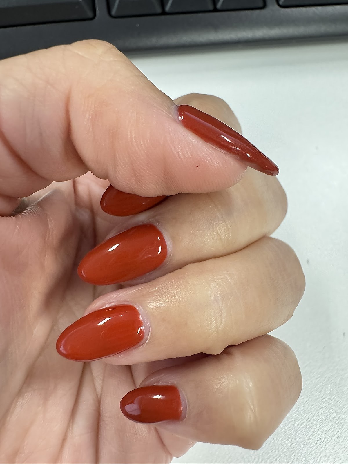 Red nail polish manicure on tidy cuticles