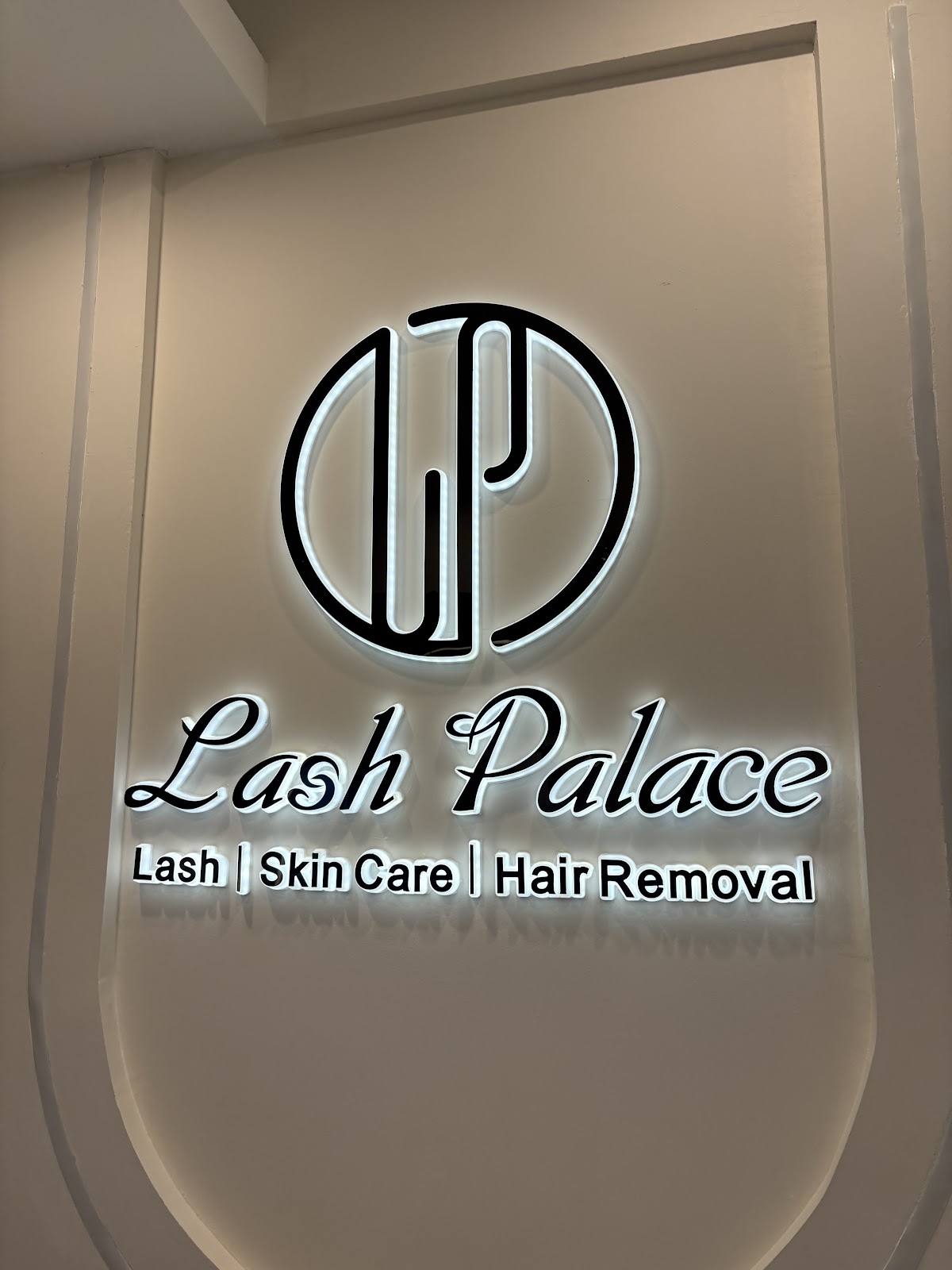 Lash Palace storefront with luminous white signage and warm interior lighting