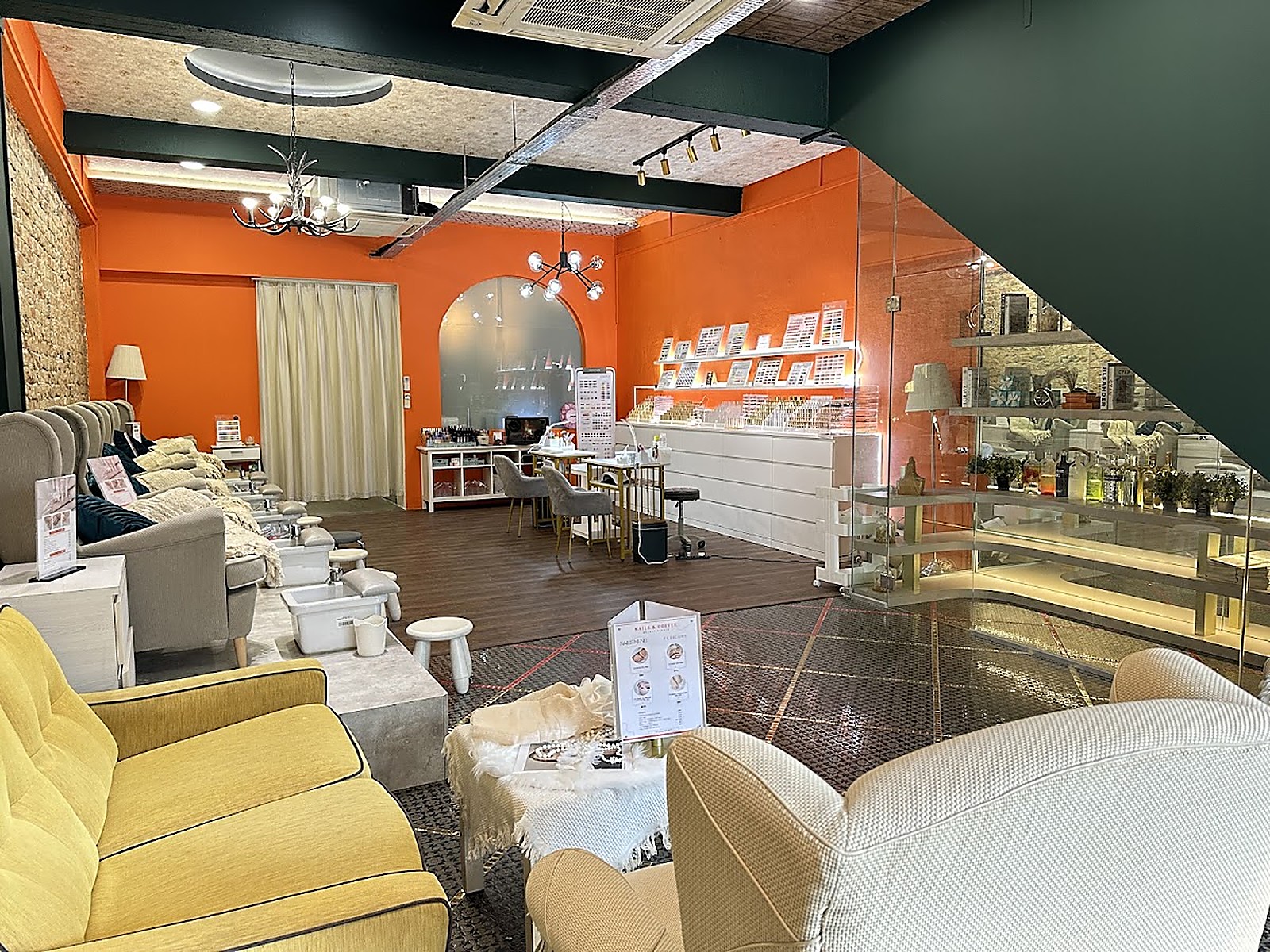 Modern salon interior space at Maison Glam with warm tangerine walls