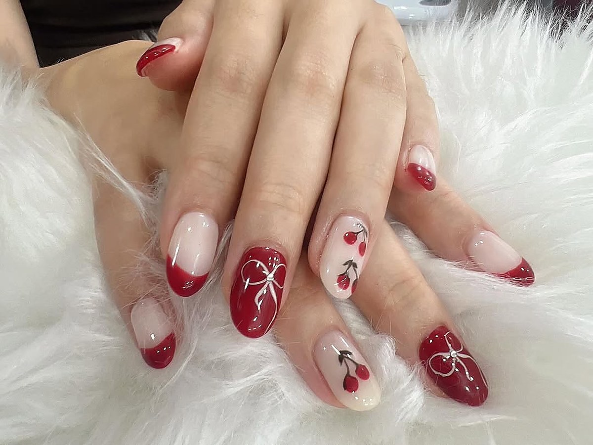 Red nail art design with painted detail