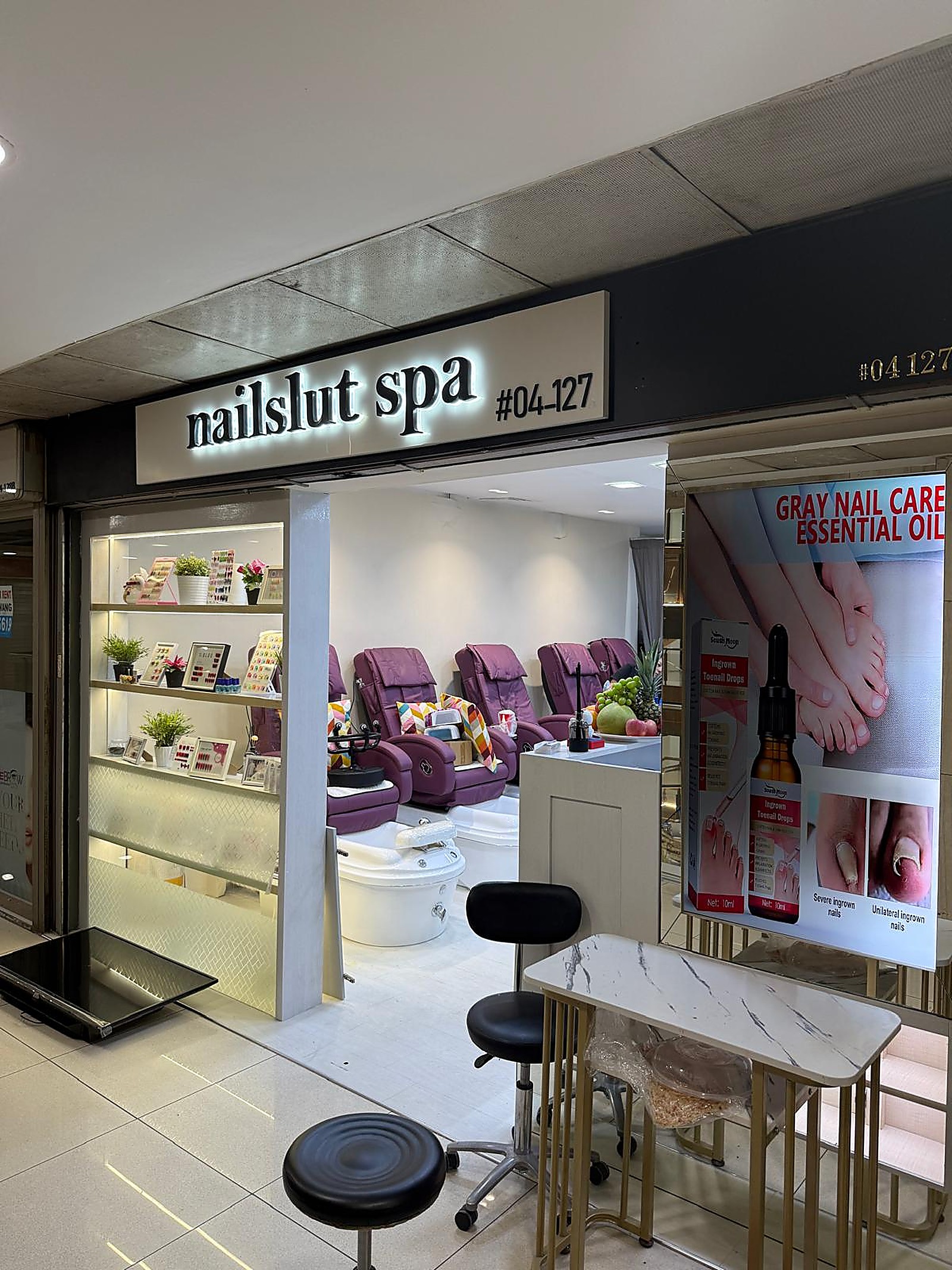Nail spa interior with plush pedicure chairs and warm neutral tones