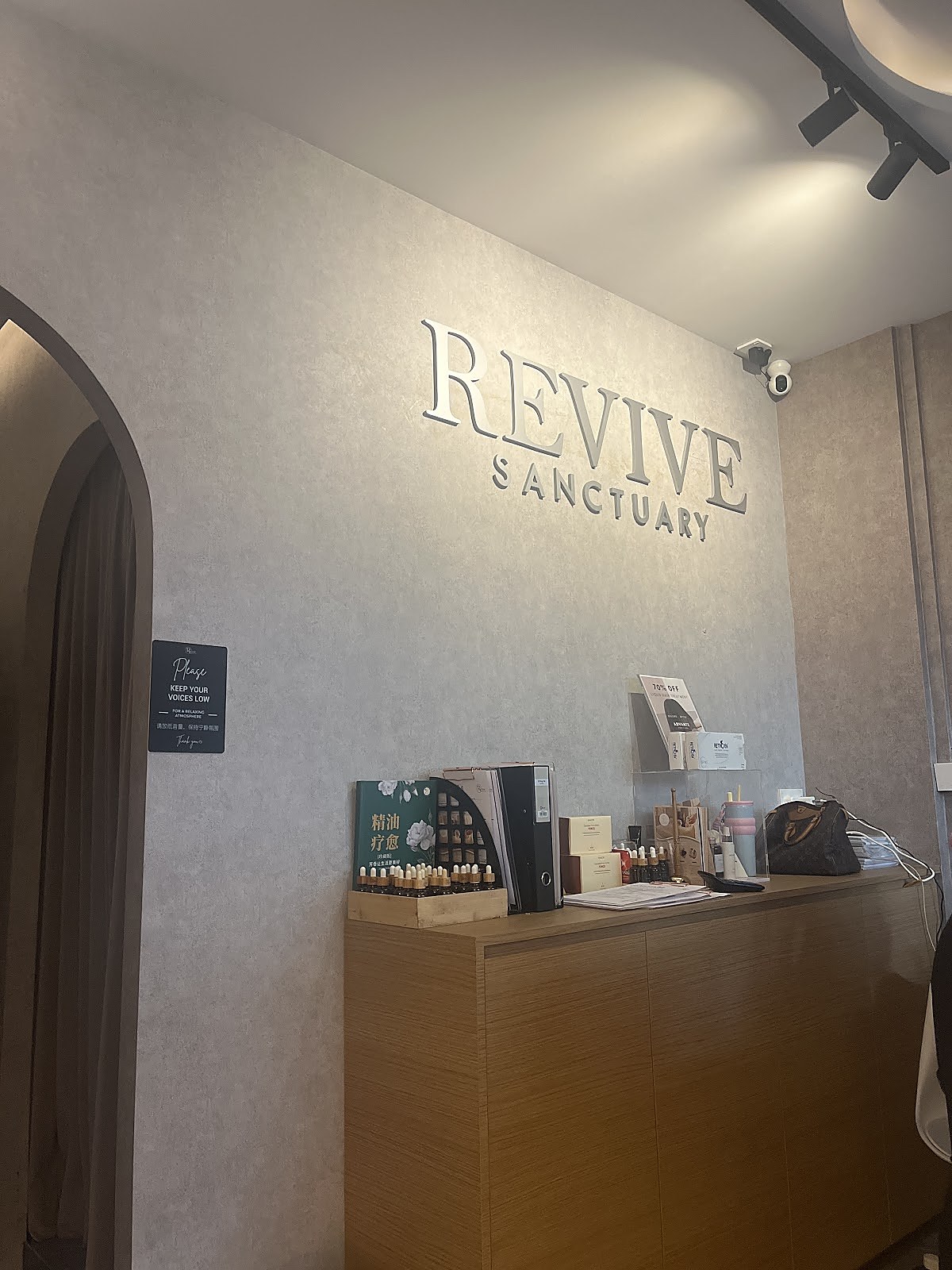 Salon reception desk with brand signage and warm interior tones
