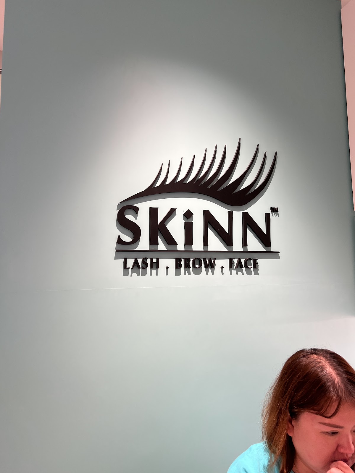 SKINNlash signage at the studio entrance