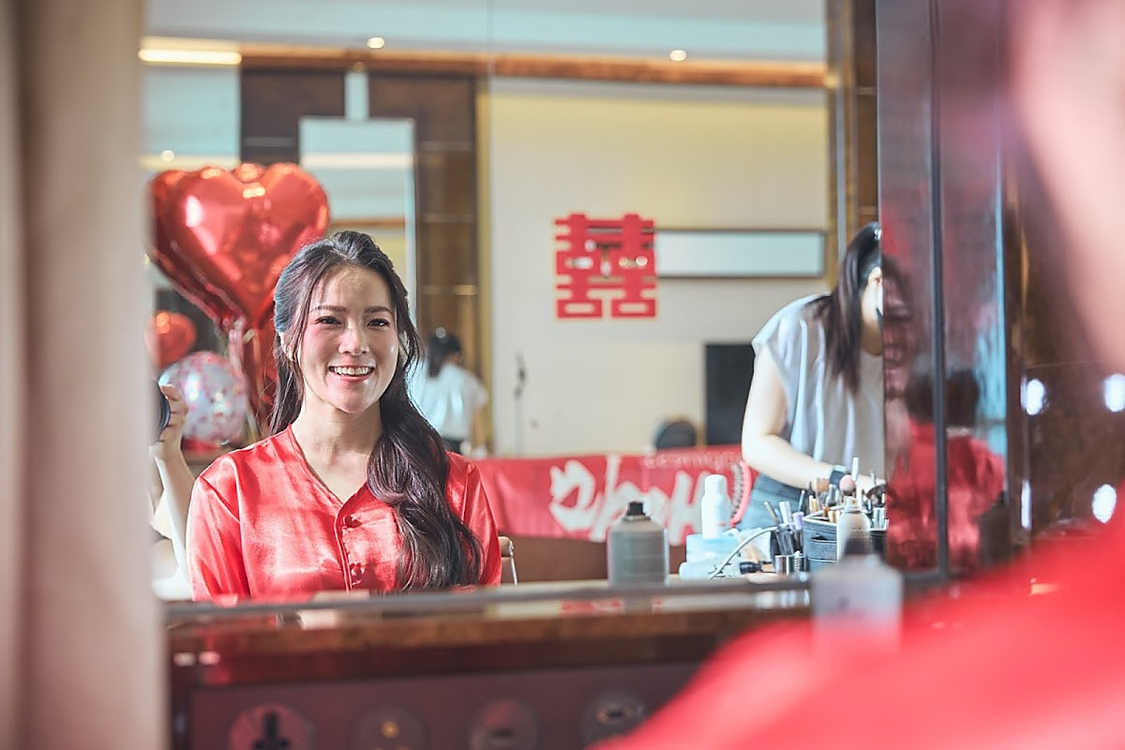 ST Bridal Makeup studio — reception counter with traditional red decor