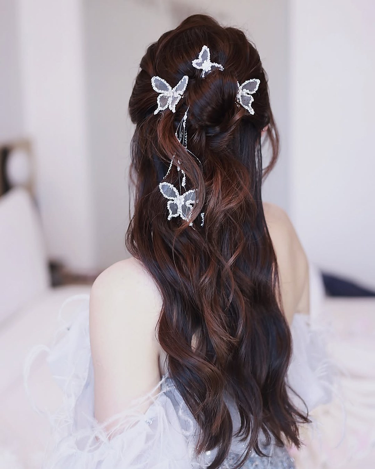 Long hair styling with butterfly hair clips