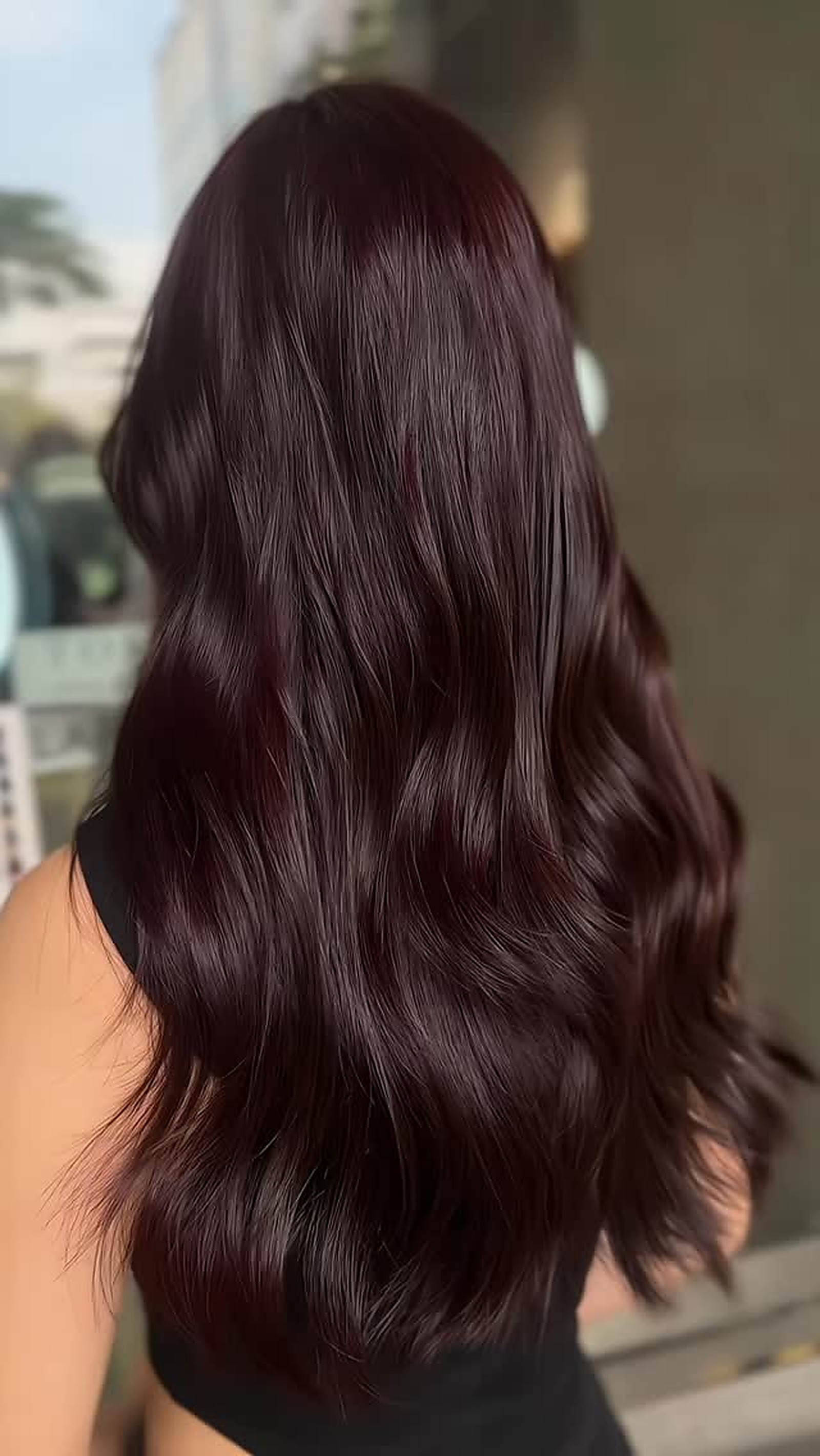 Long dark burgundy hair result styled at Styles & Smiles Studio