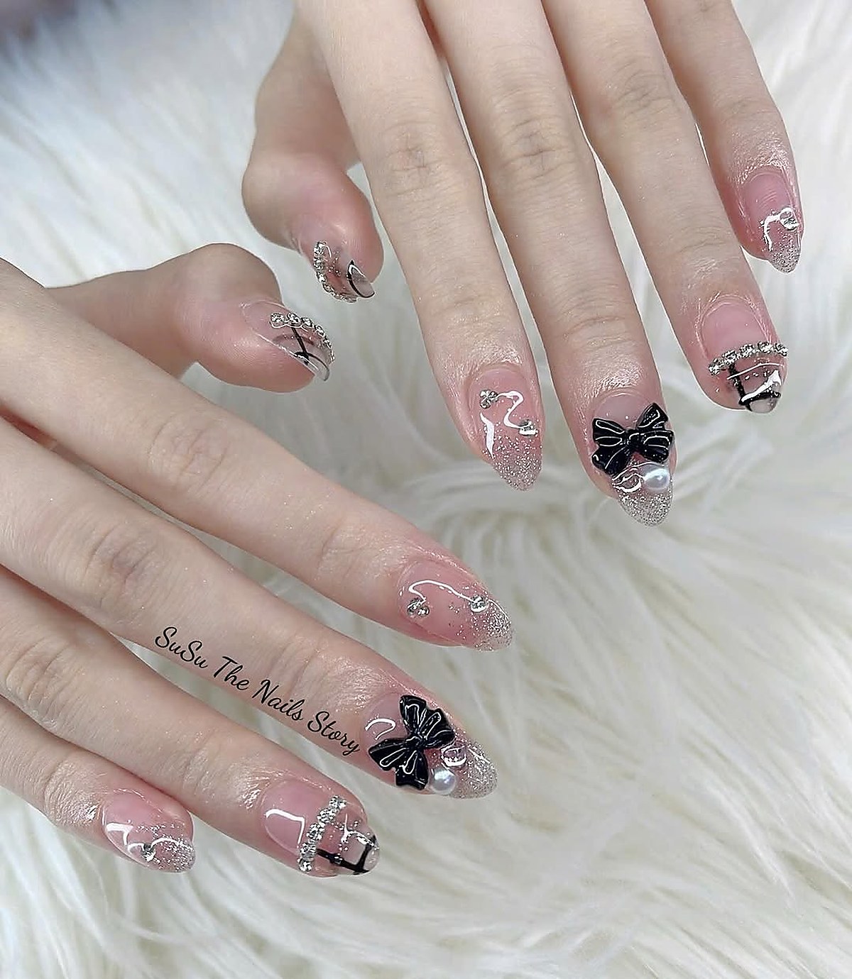 Nail art with glitter and bow detailing