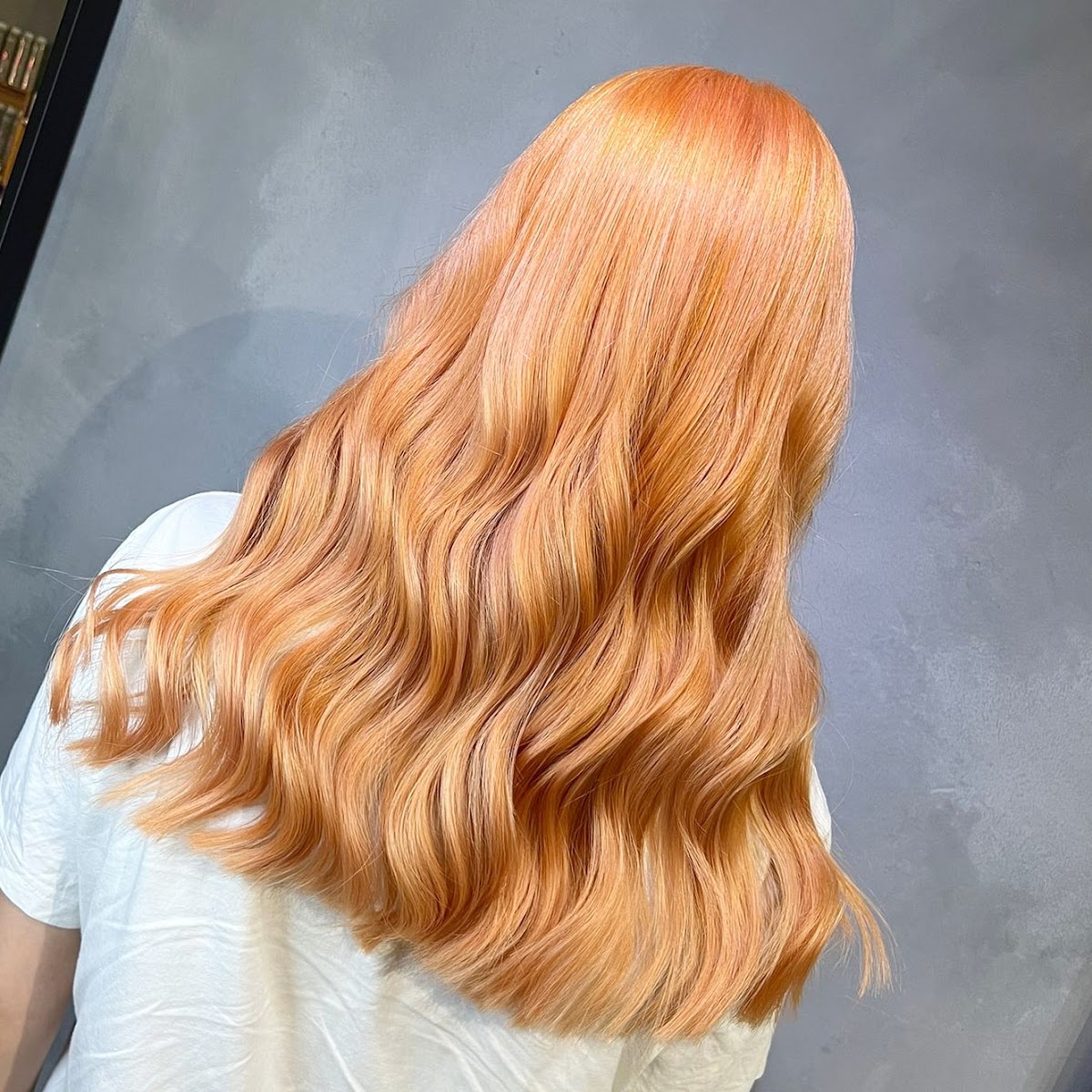 Long wavy hair colour result by The Loook Salon