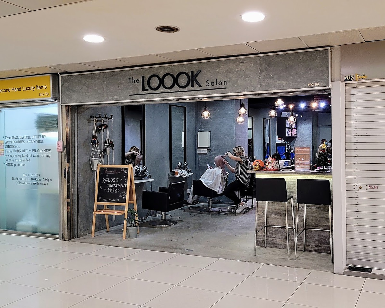 Inside The Loook Salon — calm concrete-finish treatment space with warm light