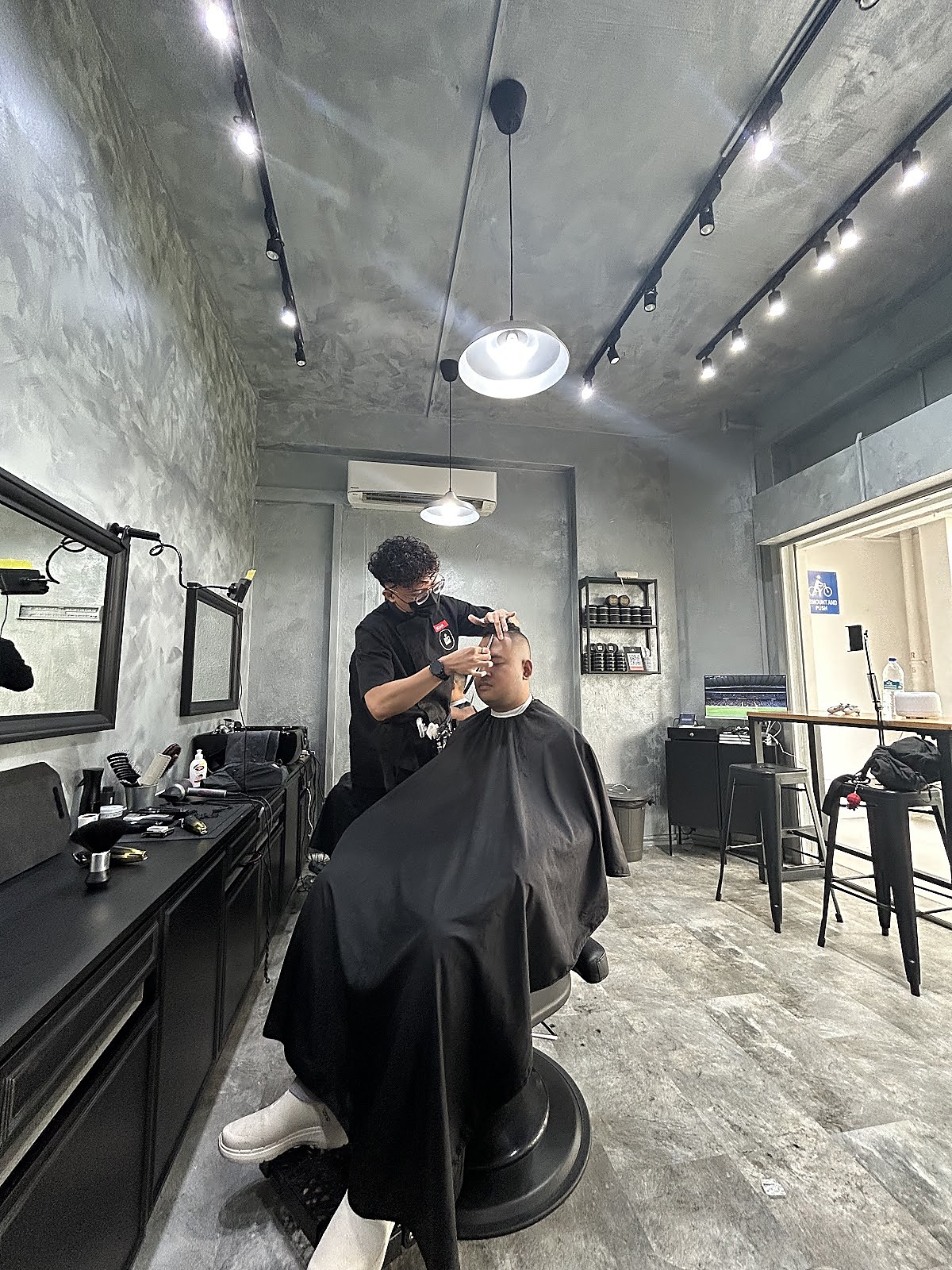 Barber styling a finished fade haircut