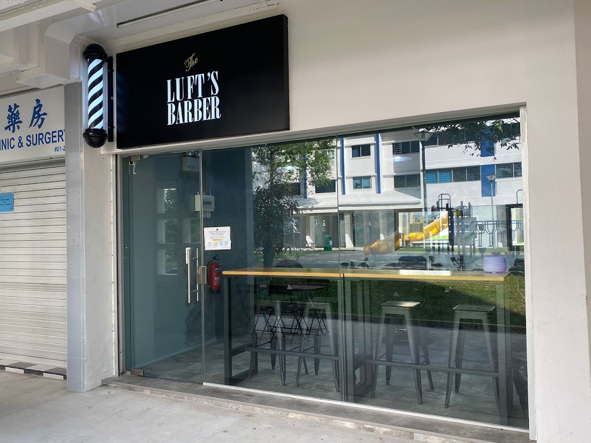 The Lufts Barber storefront in Woodlands — modern barber shop signage above the street