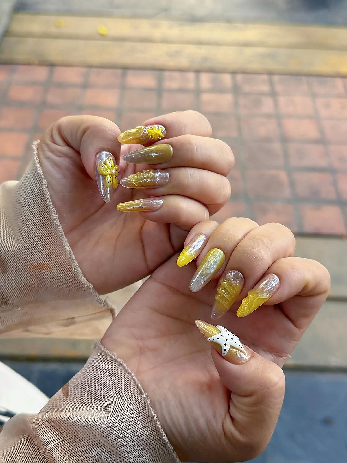 nail_art_design_result — completed nail art result, photographed on the chair